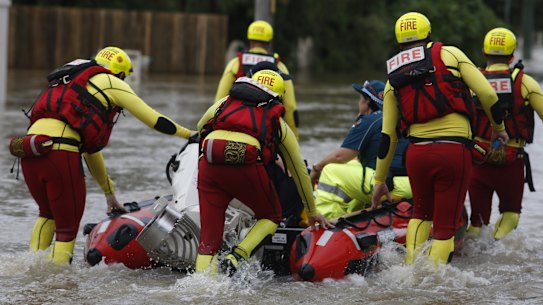 Queensland Fire and Emergency Services crew members are seen in floodwaters in Hermit Park, Townsville, Sunday, February 3, 2019.