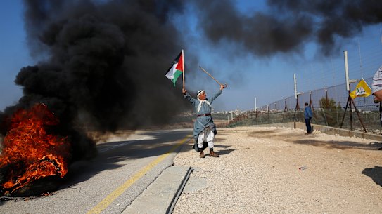 A Palestinian protests Israeli settlements  in the outskirts of the village Kafr Thulth near the West Bank town of Qalqilya, on Saturday.  Israel has ordered another 800 Jewish homes be built in the West Bank.
