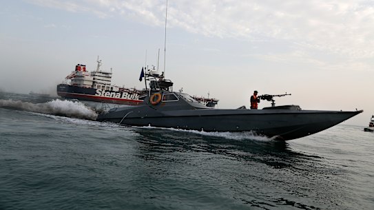 A speedboat of Iran's Revolutionary Guard moves around a British-flagged oil tanker Stena Impero, which was seized on Friday by the Guard, in the Iranian port of Bandar Abbas.
