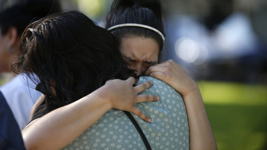 Prianna Ayala weeps as she is embraced at a memorial site for the victims killed in this week’s elementary school shooting in Uvalde, Texas.