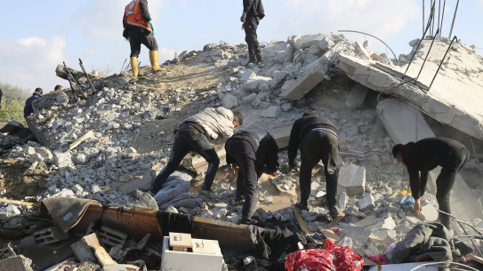 Palestinians search for survivors after an Israeli airstrike on a residential building In Rafah, Gaza Strip on Saturday.