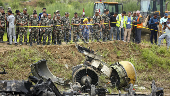 Nepal army personnel stand by a plane crash site at Tribhuvan International Airport in Kathmandu.