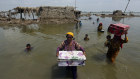 Families salvage possessions from their flooded homes in Pakistan’s Sindh province.