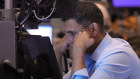 A trader works on the floor of the New York Stock Exchange.