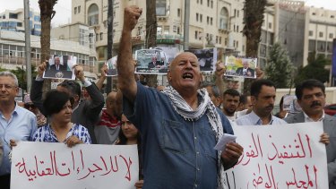 Palestinians attend a protest to demand lifting the sanctions on Gaza Strip, in the West Bank city of Ramallah, on Tuesday.