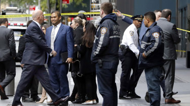 New York City Police Commissioner James P. O'Neill, left, arrives outside the Time Warner Centre, in New York, after the police bomb squad was sent to CNN's offices in New York City and the newsroom was evacuated because of a suspicious package. 
