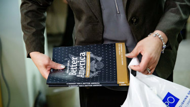 An employee bags purchased copies of US President Donald Trump's 2020 budget request in Washington.