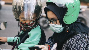 Jakarta commuters wear masks in an effort to filter out the pollution.