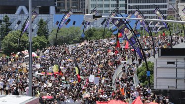 Invasion Day Protesters march across Brisbane’s Victoria Bridge
