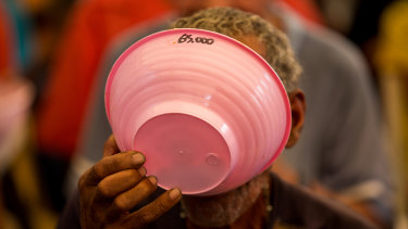 A resident eats free soup at a political rally in Vargas state, Venezuela last week.
