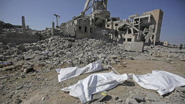 Bodies covered in plastic lie on the ground amid the rubble of a Houthi detention centre in Yemen destroyed by Saudi-led air strikes in September.