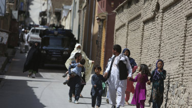 Families leaves their homes after a rocket strike in the western part of Kabul, Afghanistan, on July 24.