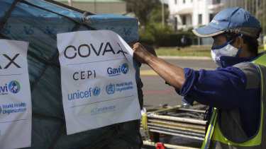 I lavoratori aeroportuali spruzzano un carico di vaccini Covax COVID-19 al loro arrivo ad Antananarivo, in Madagascar.