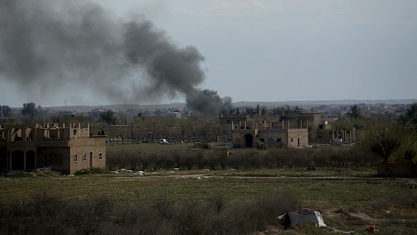 Smoke rises after a strike on Baghouz, Syria, the Islamic State group's last piece of territory.