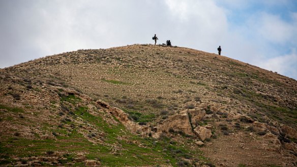 Israeli soldiers secures a hill as Israel's Prime Minister Benjamin Netanyahu visits the Jewish settlement in the Jordan Valley near the Palestinians city of Jericho. 