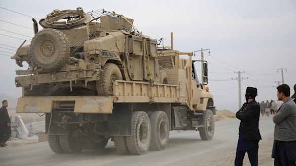 Exiting: A military vehicle damaged by a blast is transported in Kabul, Afghanistan.