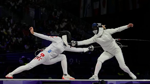 Vivian Kong (left) during fencing competition in Paris.