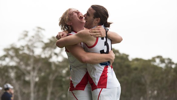 The Canberra Demons celebrate their first NEAFL finals win.
