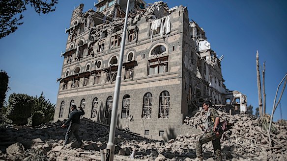 Houthi Shiite rebels inspect the rubble of the Republican Palace that was destroyed by Saudi-led airstrikes in Sanaa, Yemen in December last year.