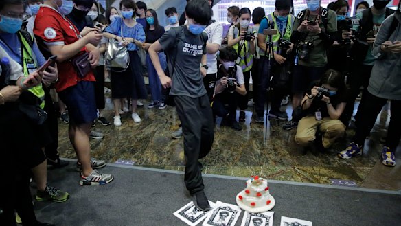 A protester steps on the placard featuring a sketch of Hong Kong Chief Executive Carrie Lam during an anti-government protest in Hong Kong.