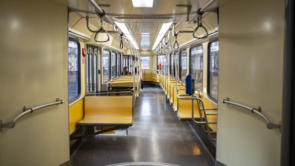 Commuters ride a deserted tram carriage in Milan.