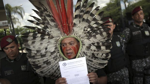 Kaigang Chief Kreta holds a letter of protest outside the transition office of President-elect Jair Bolsonaro, in Brasilia. Indigenous demands include the demarcation of native lands and the protection of the National Indian Foundation. 