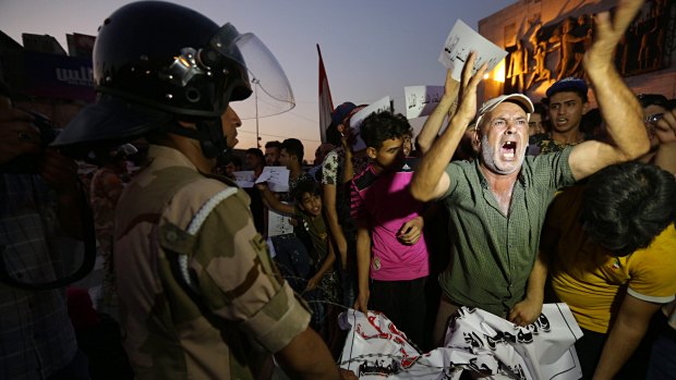 Iraqi protesters chant slogans demanding services and jobs during a demonstration in Tahrir Square, Baghdad, on  Saturday, July 14.