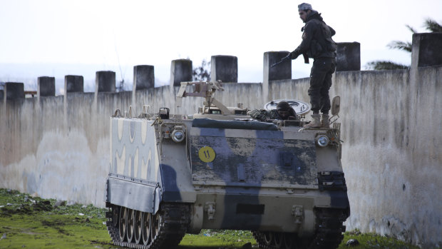 A Turkish-backed fighter prepares to go to the front line in the Syrian province of Idlib on Monday.