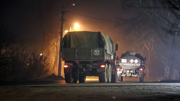 Military trucks move down a street outside Donetsk, the territory controlled by pro-Russian militant.