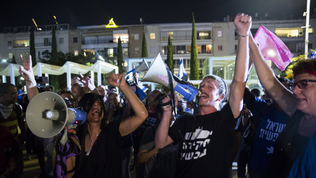 Israelis gather in a rally to support a unity government to oust Israeli Prime Minister Benjamin Netanyahu from office on Monday.