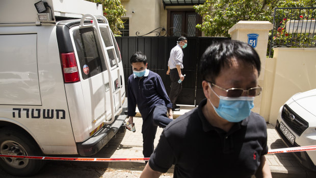 Men leave the house of China's ambassador to Israel, Du Wei, after he was found dead in his home in Herzliya, Israel.