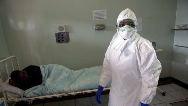 A Zimbabwean nurse wears protective clothing during an exercise simulating a fictional coronavirus case, at a hospital in Harare.
