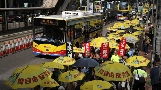 Pro-democracy protesters carry a banner with Chinese reads "Vindicate June 4th" during a demonstration in Hong Kong,