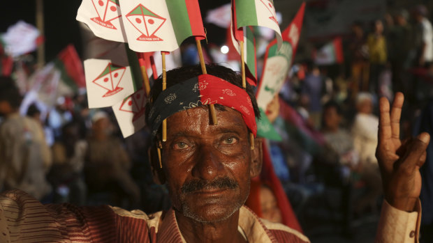A supporter of Pakistani political party MQM attends an election rally in Karachi on Monday.