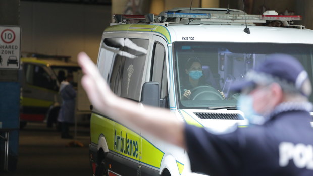 Police direct ambulances as they exit the Westin Hotel in Brisbane's CBD on Wednesday afternoon.