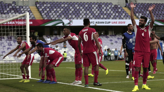 Boilover: Jordan's players celebrate after their shock 1-0 win over Australia in the Group B opener.