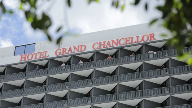 Guests at the Hotel Grand Chancellor stand on their balconies ahead of an operation to move them from the quarantine site in early January. 