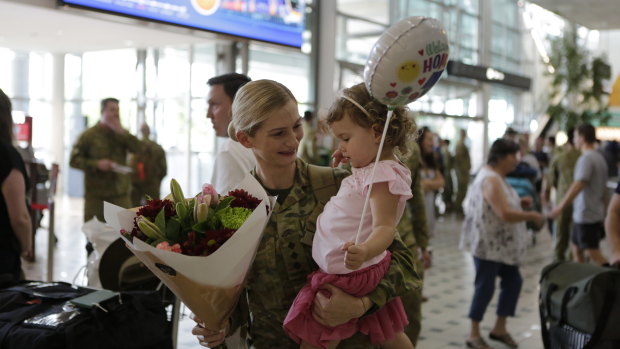 Captain Morgan Kiss is greeted by her two-year-old daughter, Charlotte, on returning from a six-month deployment to Iraq.