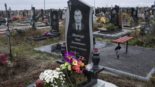 The headstone of Ivan Mamchur, a Ukrainian prison guard and military veteran who was murdered in Rivne, a city in western Ukraine.