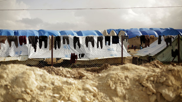 Laundry dries on a chain-link fence at Al-Hol camp, in the section where foreign families from Islamic State-held areas are housed, Hasakeh province, Syria. 