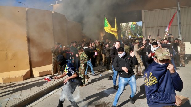 US soldiers fire tear gas towards protesters who broke into the US embassy compound in Baghdad.