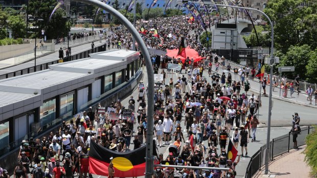 Invasion Day Protesters march across Brisbane’s Victoria Bridge