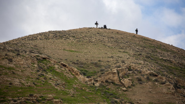 Israeli soldiers secures a hill as Israel's Prime Minister Benjamin Netanyahu visits the Jewish settlement in the Jordan Valley near the Palestinians city of Jericho. 