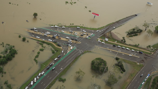 Stranded vehicles as the floods engulf the intersection of Stuart Drive and the Bruce Highway in Townsville.