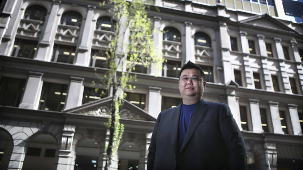  iProperty Group CFO Michael Gu in front of the company's property at 333 Kent St, Sydney.