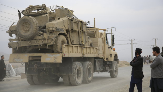 Exiting: A military vehicle damaged by a blast is transported in Kabul, Afghanistan.