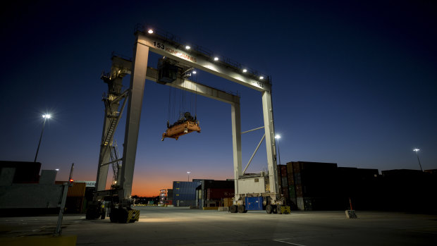 A rubber tire gantry moves into position to transfer shipping containers at the Georgia Ports Authority's Port of Savannah in Savannah, Georgia. 