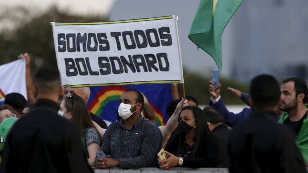 Crowds gather in front of the Planalto presidential palace to show their support for Brazil's President Jair Bolsonaro most days. The sign reads "We are all Bolsonaro" in Portuguese.