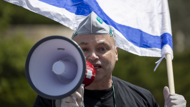 An Israeli supporter of Prime Minister Benjamin Netanyahu protests in front Israel's Supreme Court, in Jerusalem on Tuesday.