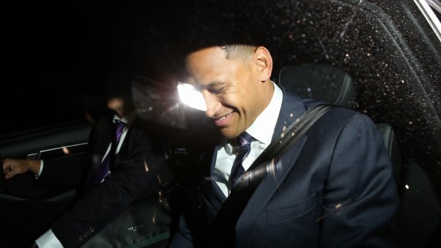 Folau laughs as he leaves Rugby Australia offices on Sunday night. 